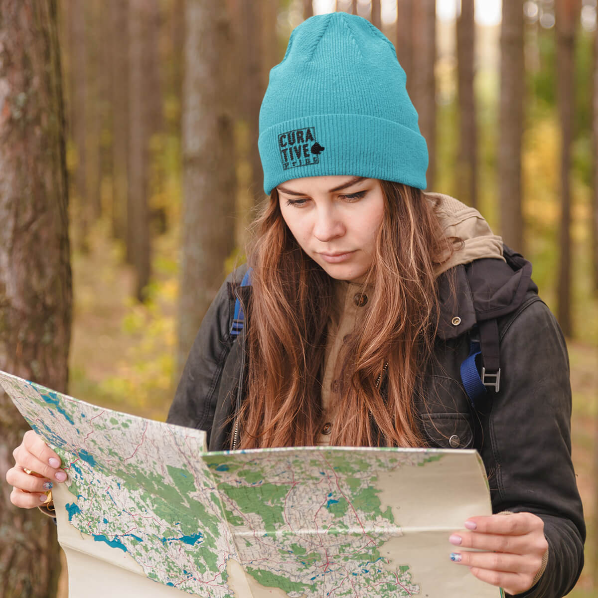 Woman wearing Curative Printing Beanie in turquoise.  