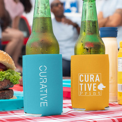 Drinks at picnic in turquoise and orange can cooler custom promotional drinkware by curative printing