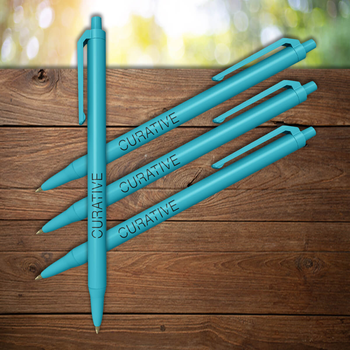 Turquoise click with black imprint custom plastic pens promotional writing implements by curative printing