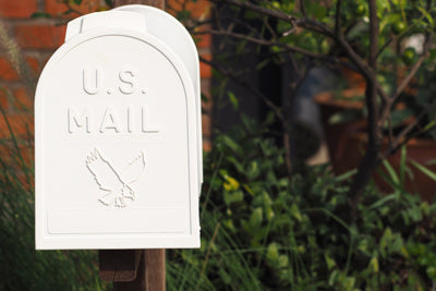 White mailbox outside of a home representing Curative's Direct Mail Service