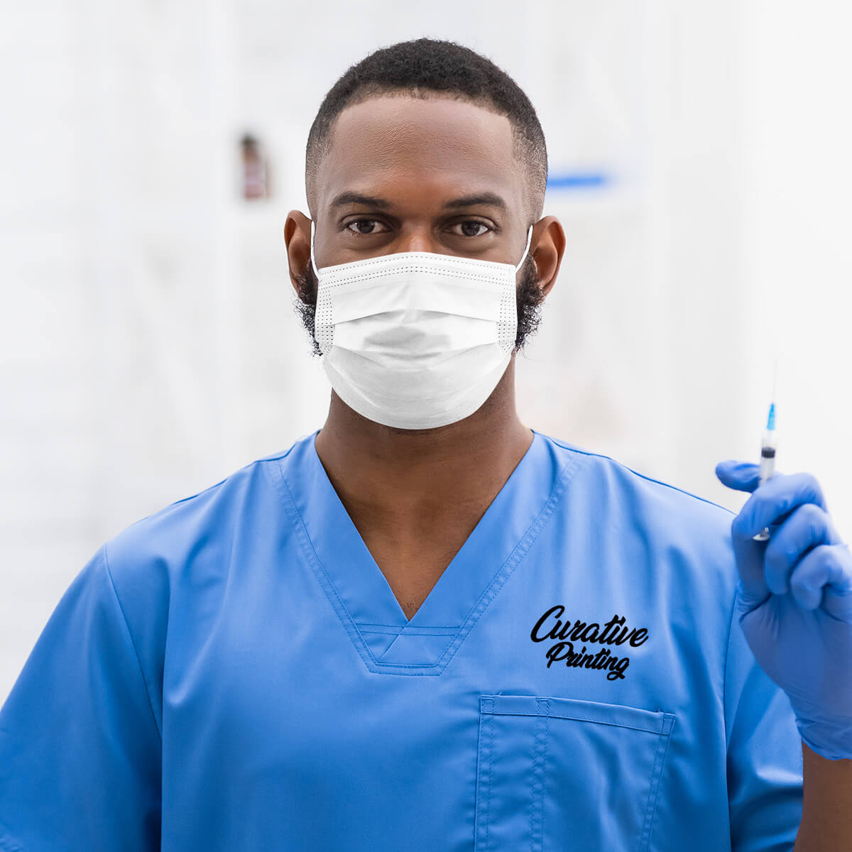 Male medical professional in blue custom branded scrub apparel promotional wellness & safety by curative printing