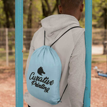 Man wearing light blue custom promotional drawstring bags by curative printing