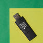 Green background with black USB flash drive promotional technology by curative printing