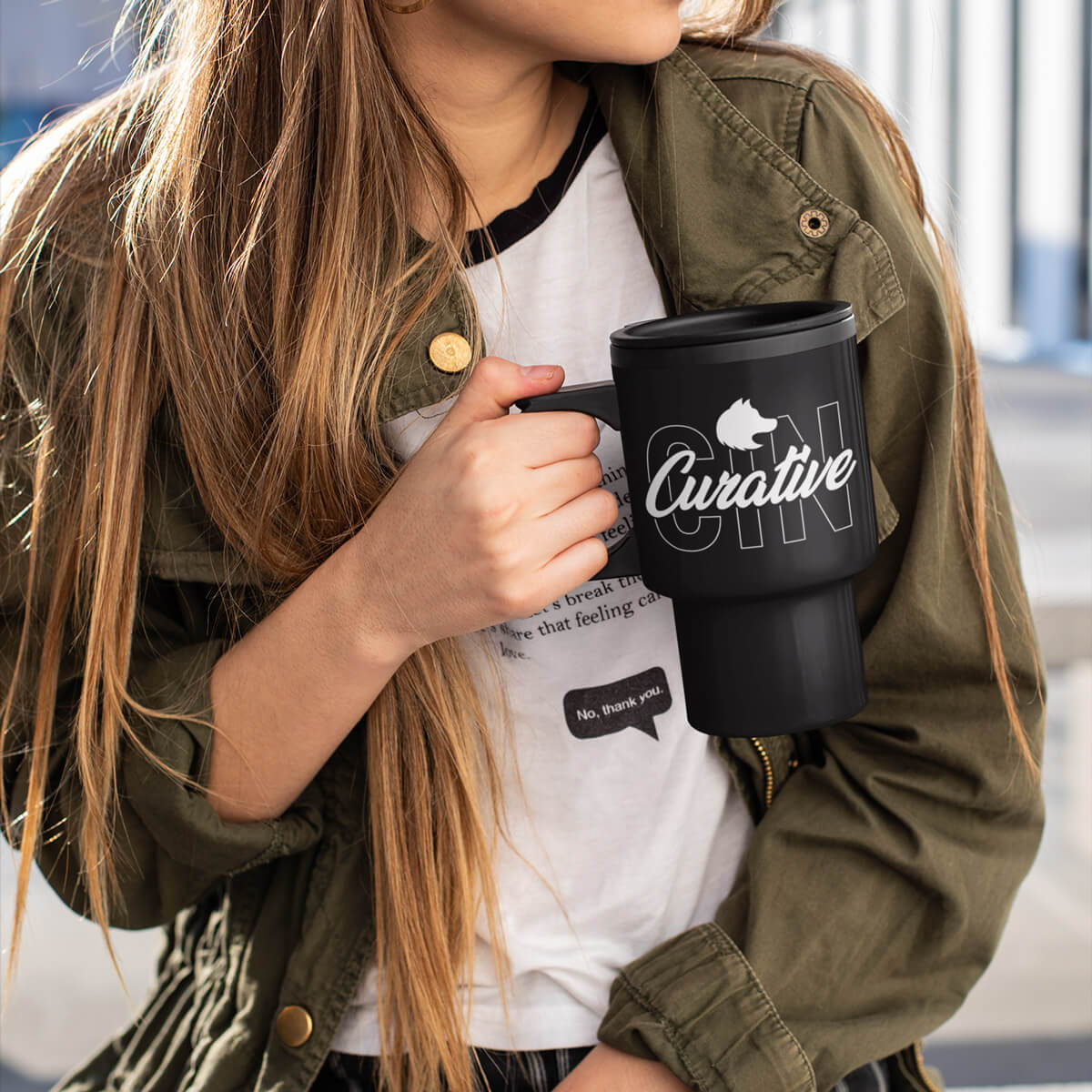 Woman holding black travel mug tumbler custom promotional drinkware by curative printing