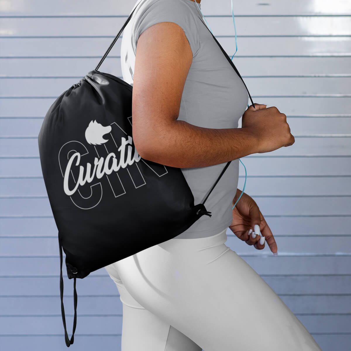 Woman wearing black custom promotional drawstring bags by curative printing