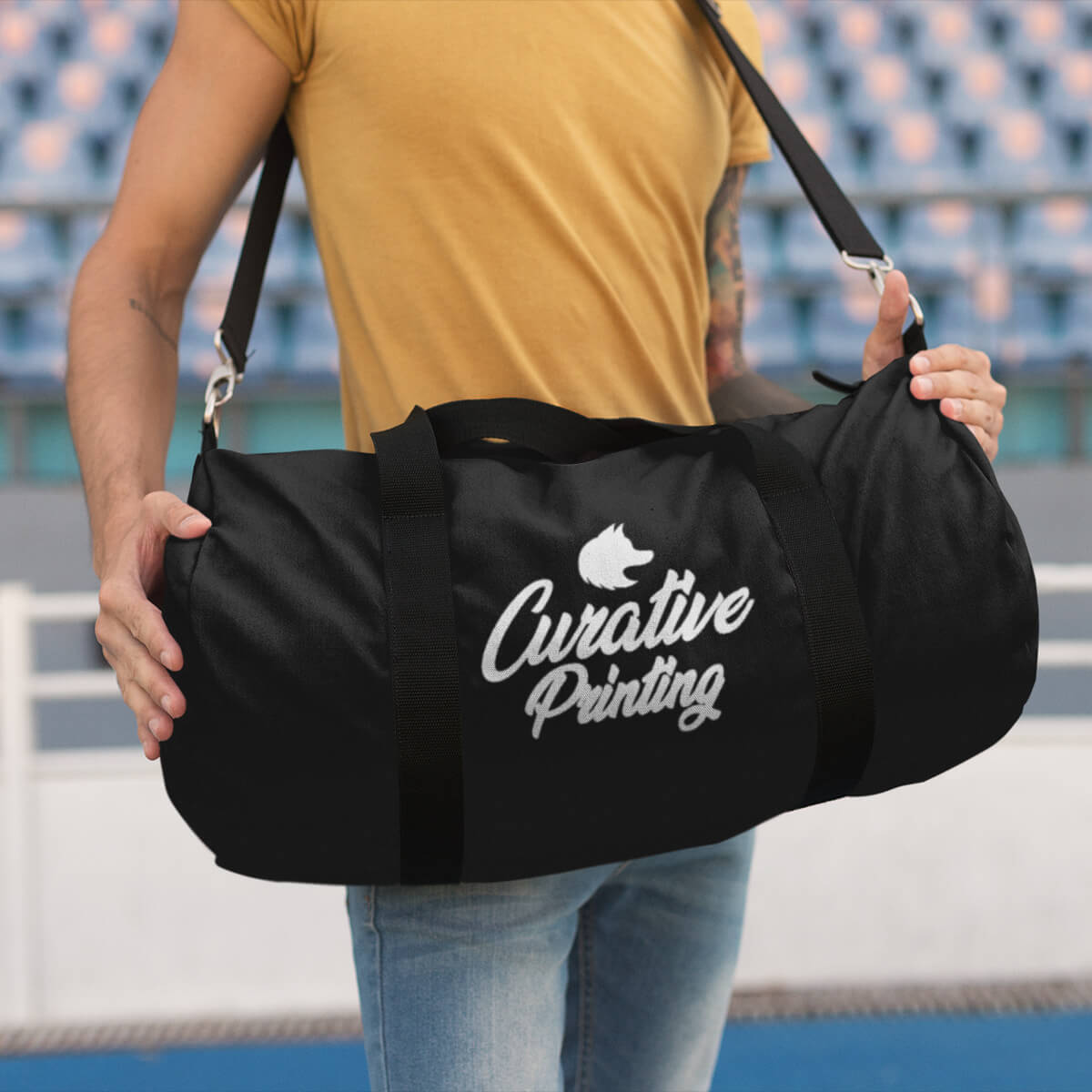 Man carrying black custom promotional duffle bags by curative printing