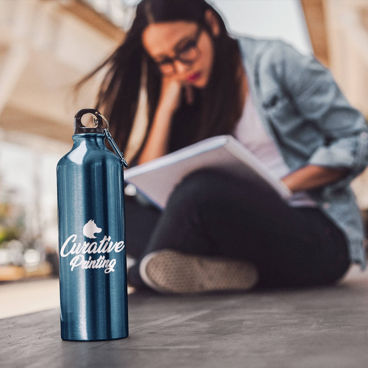 Woman with metallic blue sports bottle custom promotional drinkware by curative printing