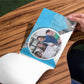 Person at a table holding blue paper booklet custom print by Curative Printing