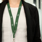 Business woman wearing green with white imprint lanyard promotional wellness & safety by curative printing