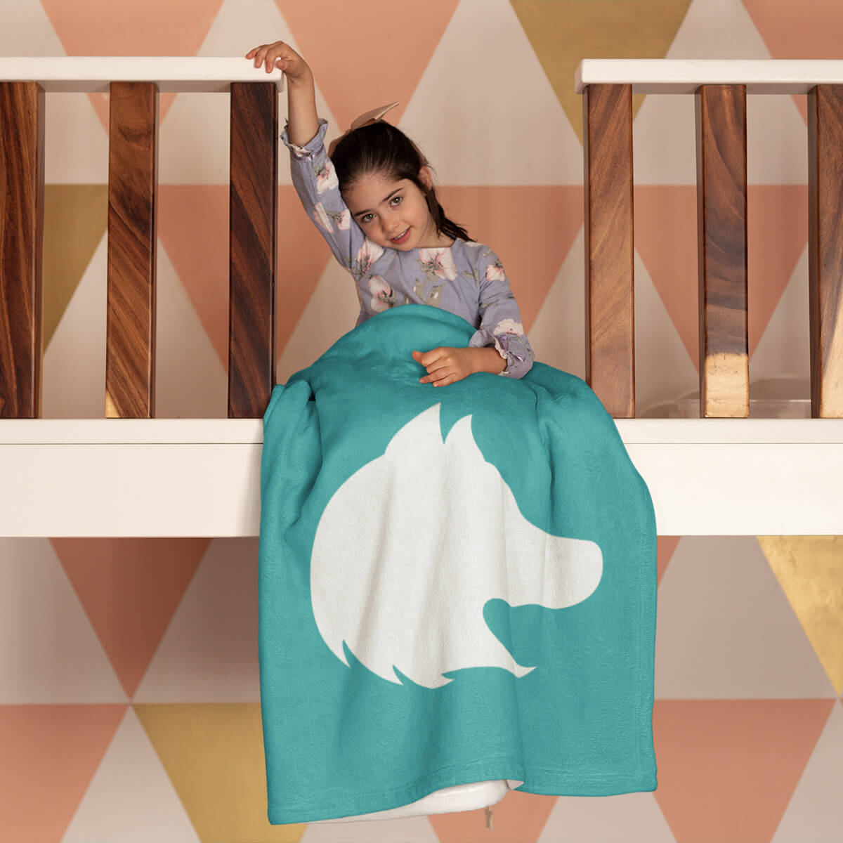 Girl sitting in a turquoise custom promotional throw blankets by curative printing