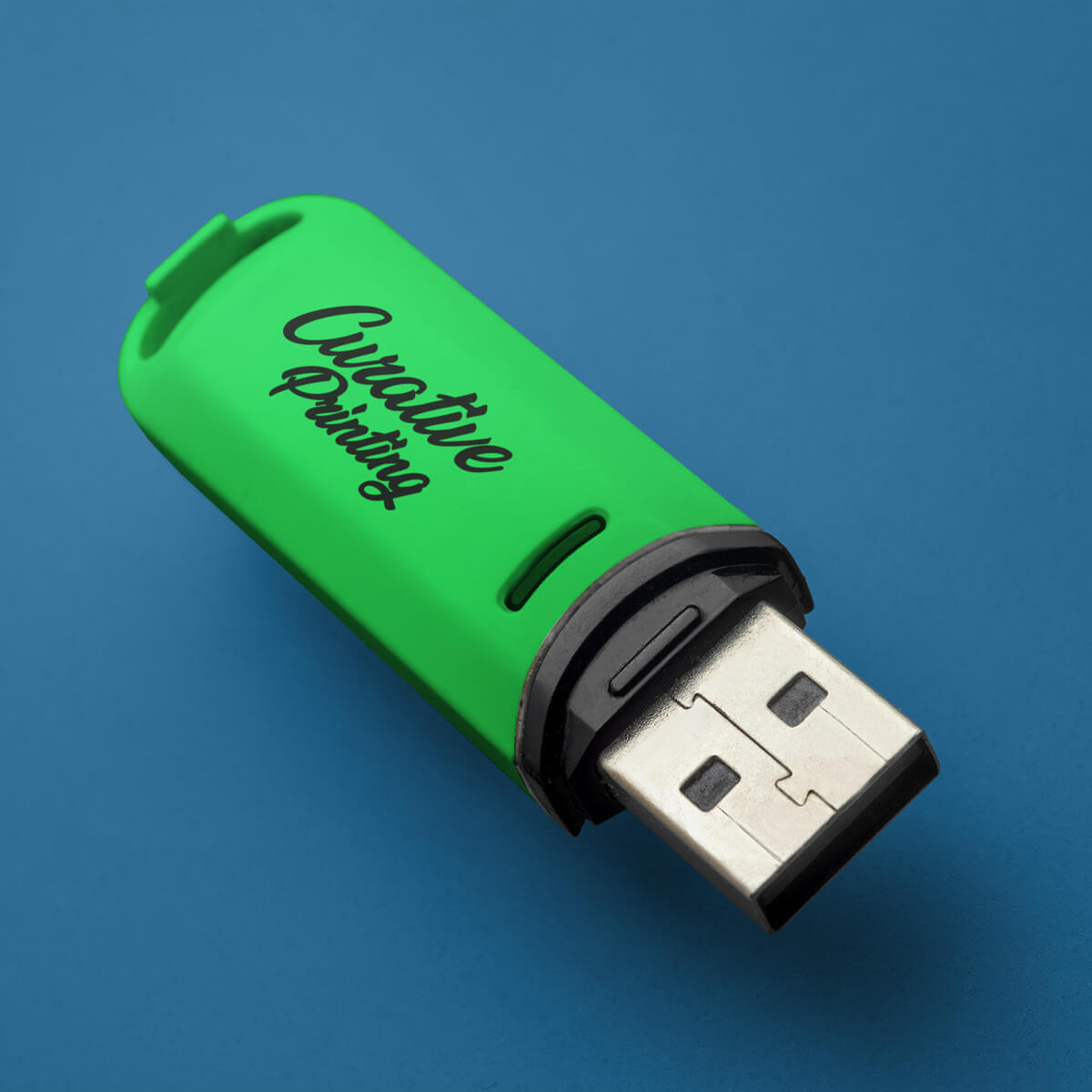 Navy background behind a green USB flash drive promotional technology by curative printing
