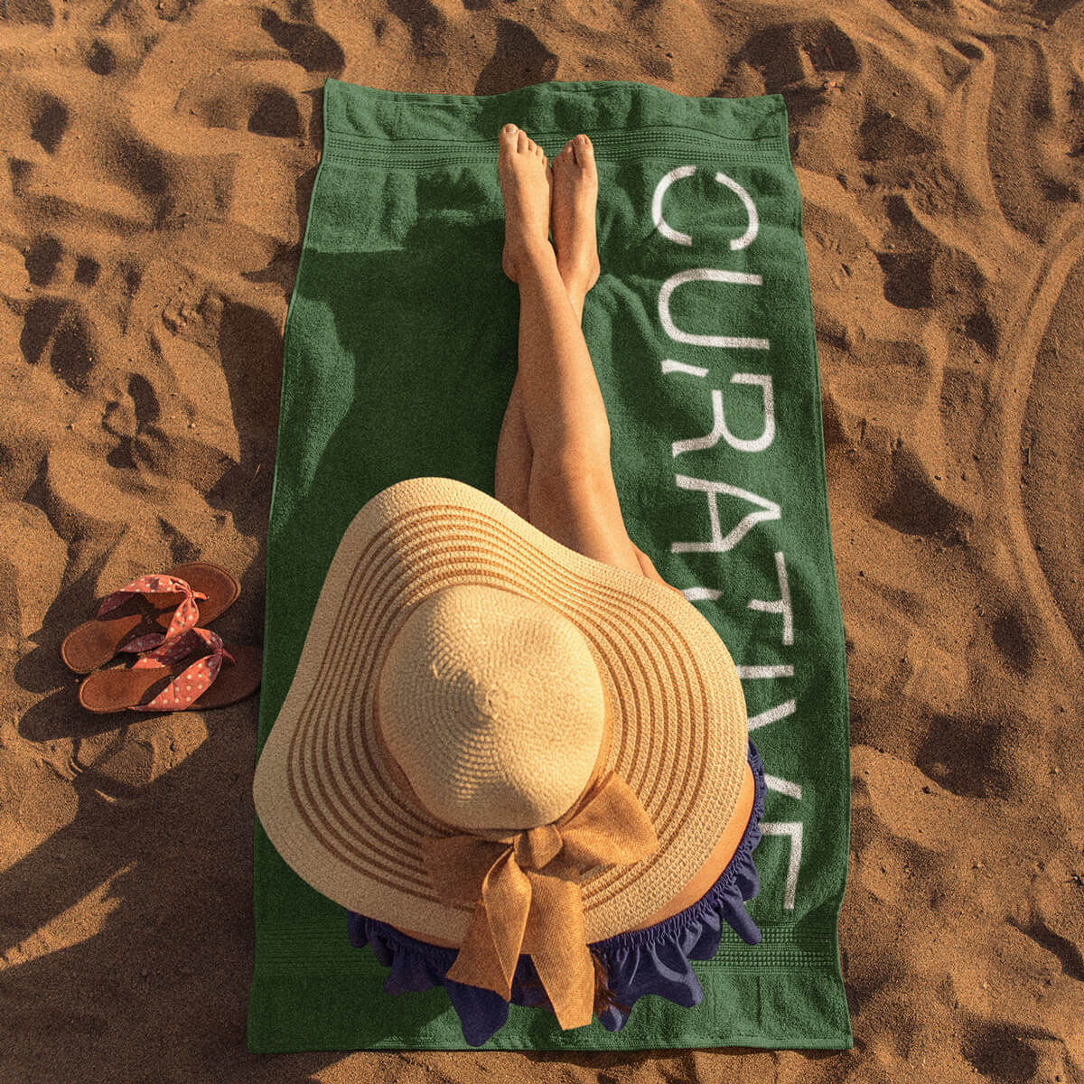 Woman laying on green beach towel promotional towels by curative printing