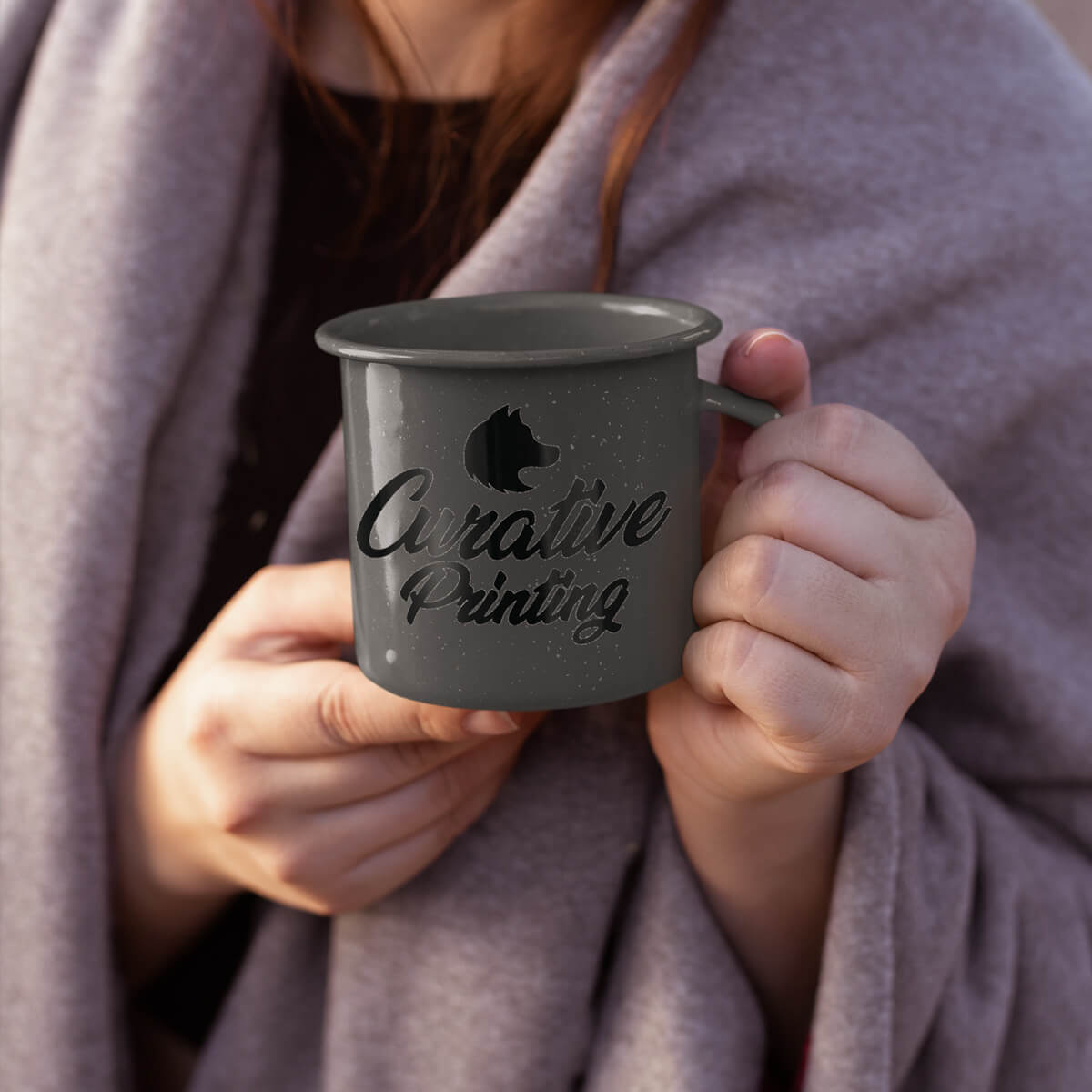 Woman holding grey enamel mugs custom promotional drinkware by curative printing