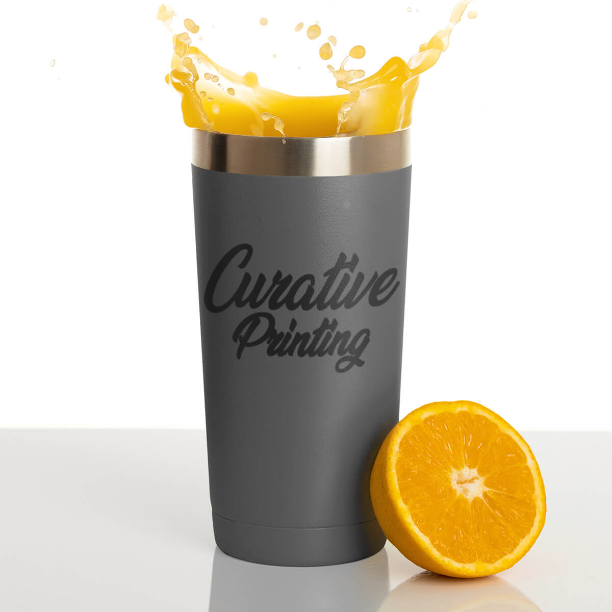 Orange juice splashing grey travel mug tumbler custom promotional drinkware by curative printing
