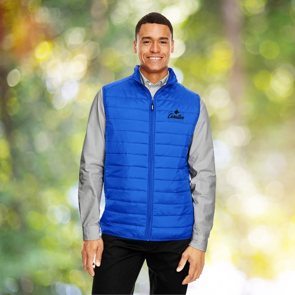 Man outdoors wearing blue vest outerwear apparel with black curative printing logo imprint