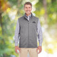 Man outdoors wearing grey vest outerwear apparel with black curative printing logo imprint