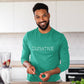 Man in kitchen wearing a green long sleeve t-shirt tee with white curative printing logo imprint