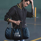 Man walking with navy custom promotional duffle bags by curative printing