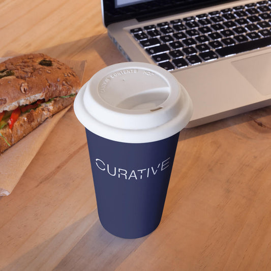 Desktop with navy plastic cup custom promotional drinkware by curative printing