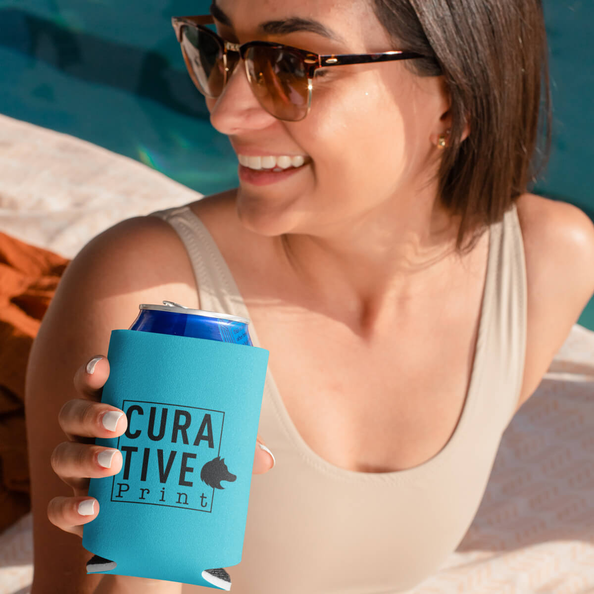 Woman drinking from turquoise can cooler custom promotional drinkware by curative printing