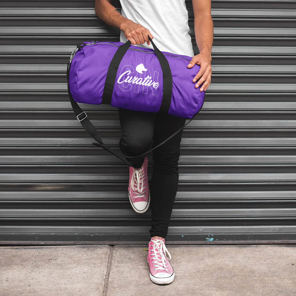 Trendy guy with purple custom promotional duffle bags by curative printing