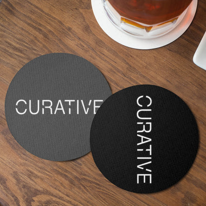 Table top with grey and black round coaster custom promotional drinkware by curative printing