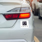 White car in traffic with square white bumper sticker promotional decal label by Curative Printing
