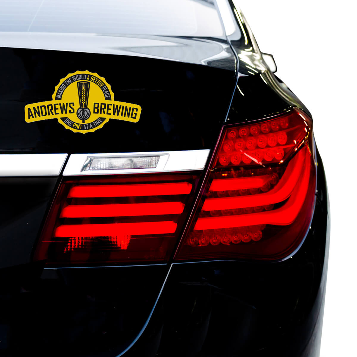 Black car bumper with die cut yellow badge bumper sticker promotional decal label by Curative Printing