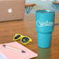 Trendy desk with turquoise travel mug tumbler custom promotional drinkware by curative printing