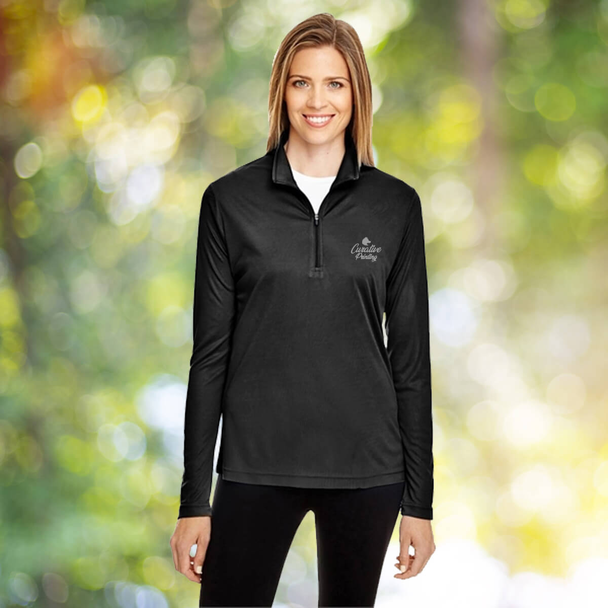Woman in the outdoors wearing black quarter zip sweatshirt apparel with white curative printing logo imprint