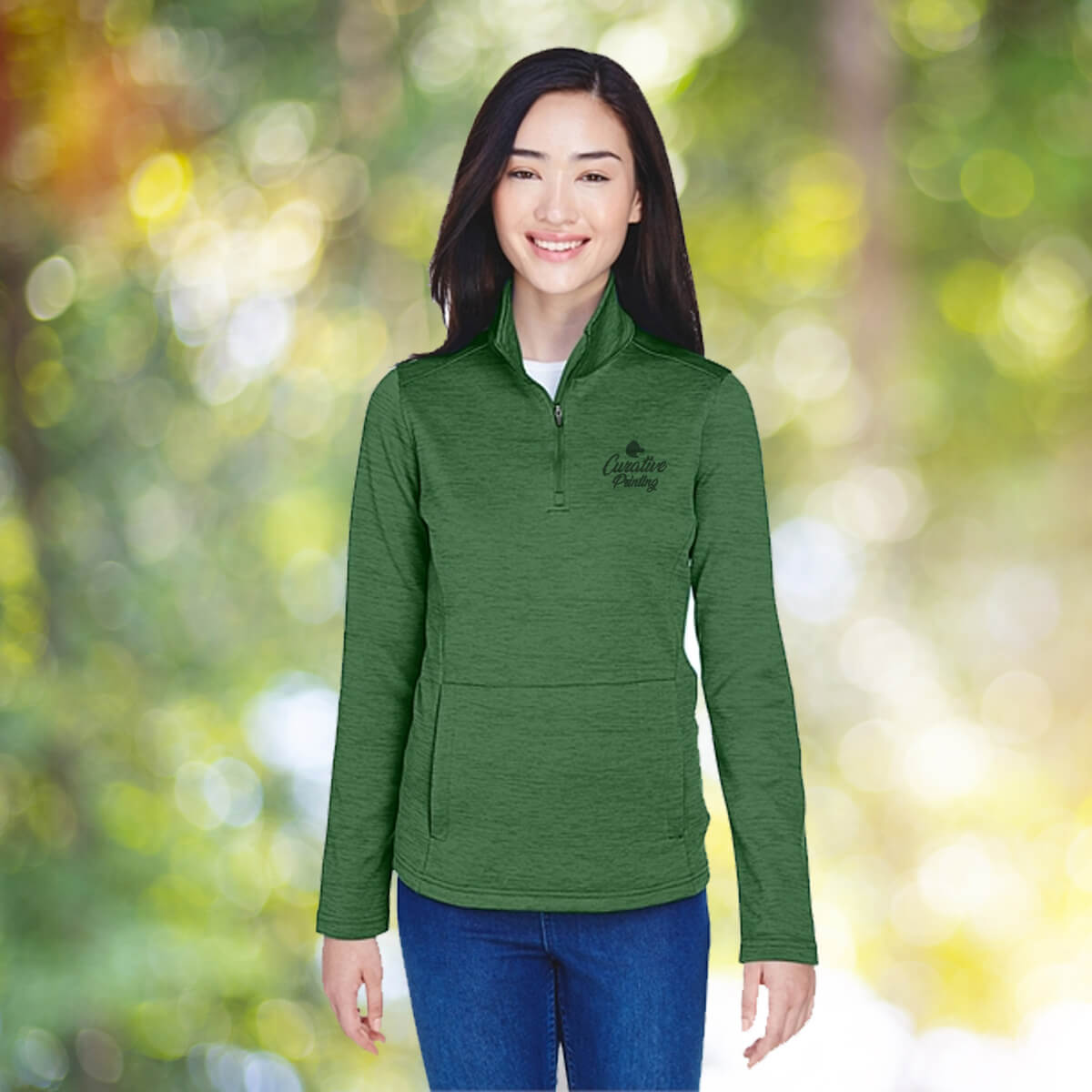 Woman in the outdoors wearing green quarter zip sweatshirt apparel with black curative printing logo imprint