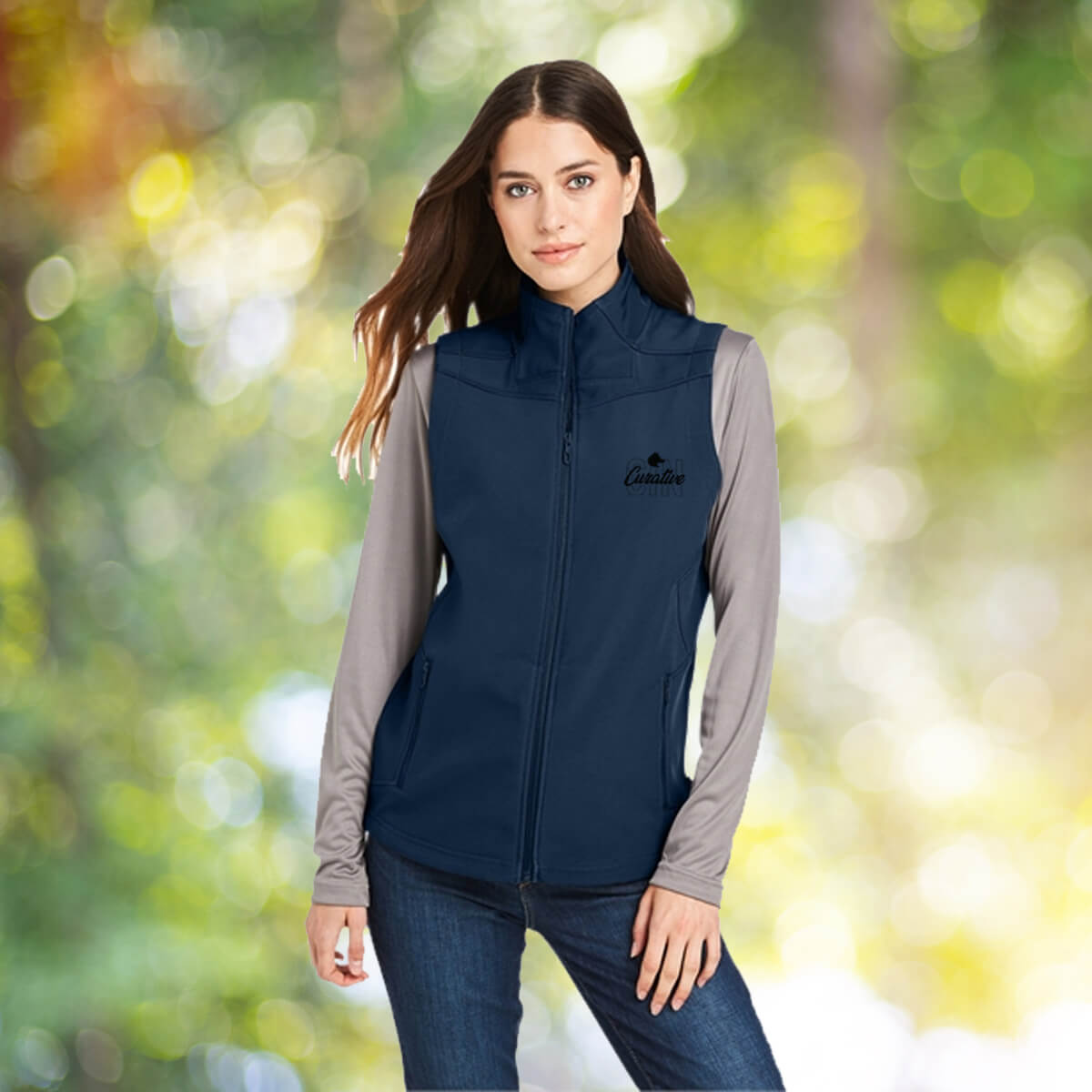 Woman outdoors wearing navy vest outerwear apparel with black curative printing logo imprint