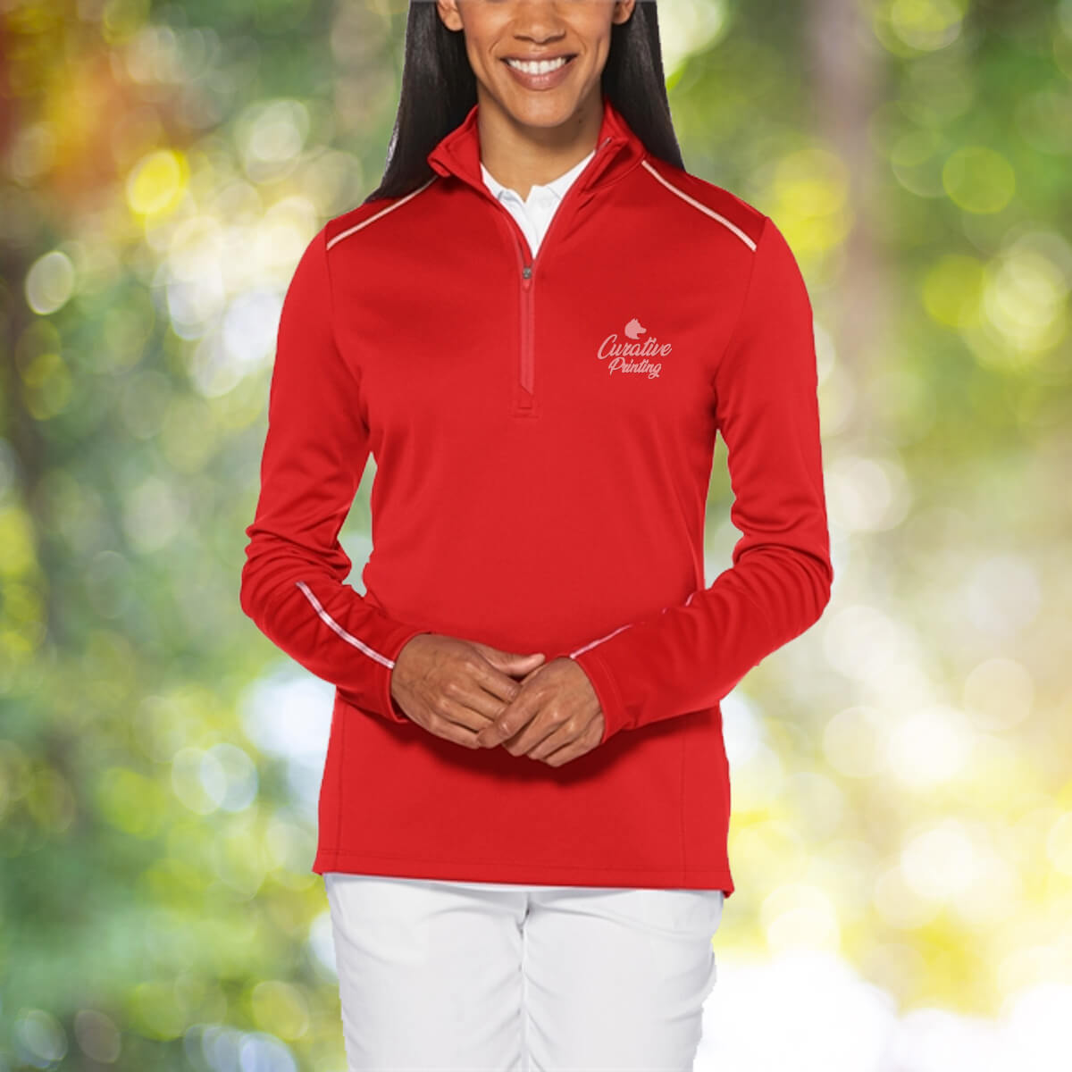 Woman in the outdoors wearing red quarter zip sweatshirt apparel with white curative printing logo imprint
